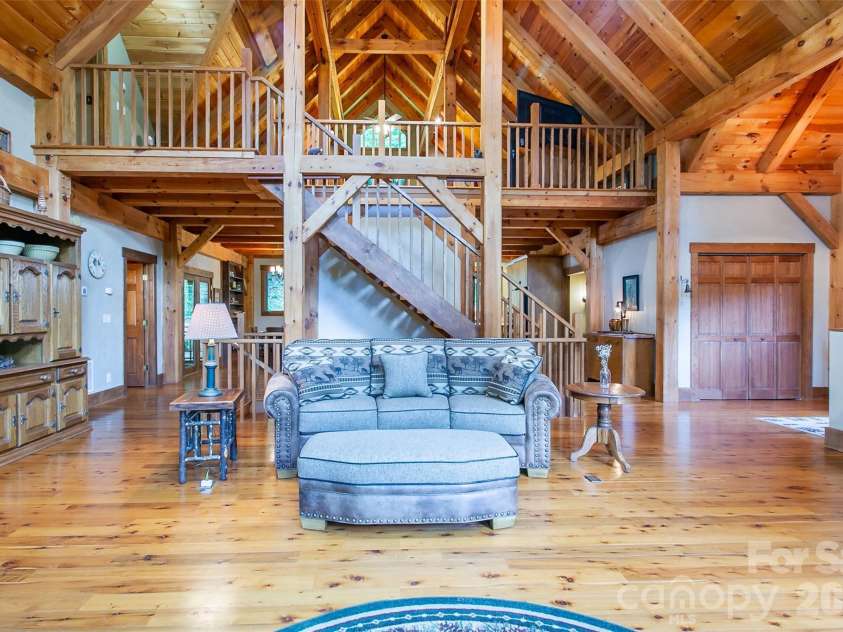58 Great Aspen Way, Black Mountain, NC 28711.  MLS# CAR4366858, YatesRealty ID 11545. Looking directly at the loft and stairway to the loft as well as downstairs. Note the beautiful wood floors.