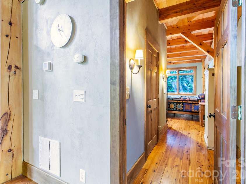 58 Great Aspen Way, Black Mountain, NC 28711.  MLS# CAR4366858, YatesRealty ID 11545. Looking down the hall into the ensuite primary bedroom. The door to the walk-in closet is pictured on the left.