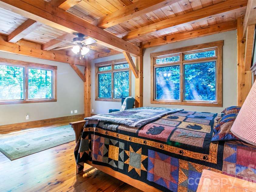 58 Great Aspen Way, Black Mountain, NC 28711.  MLS# CAR4366858, YatesRealty ID 11545. The large ensuite primary bedroom also has year-round mountain views.