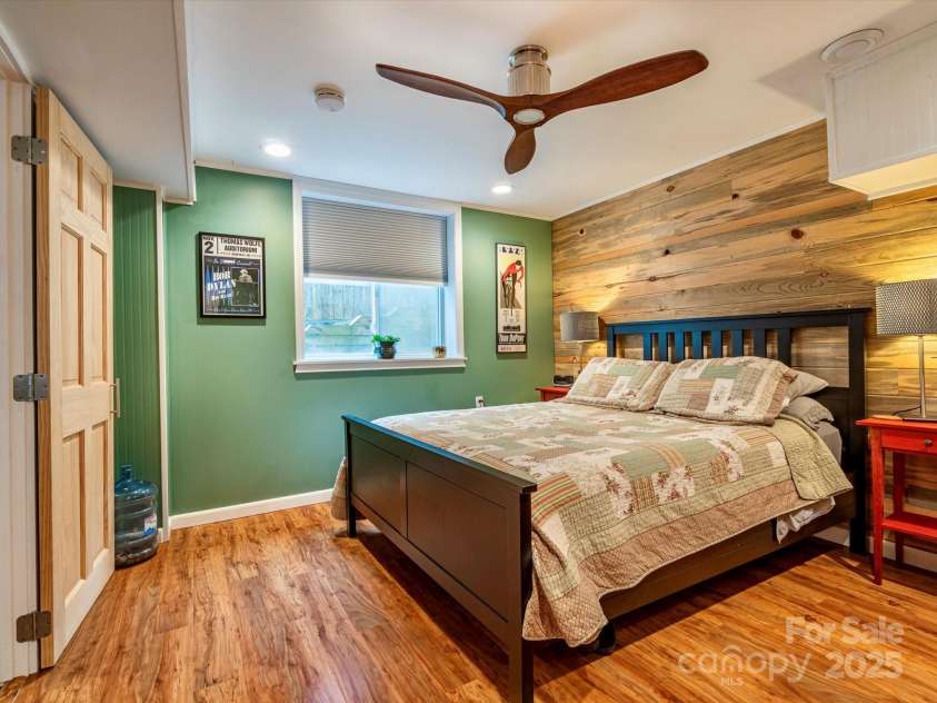 298 Town Mountain Road, Asheville, NC 28804.  MLS# CAR4256466, YatesRealty ID 11556. A large window makes this bedroom feel like main level living in the basement!