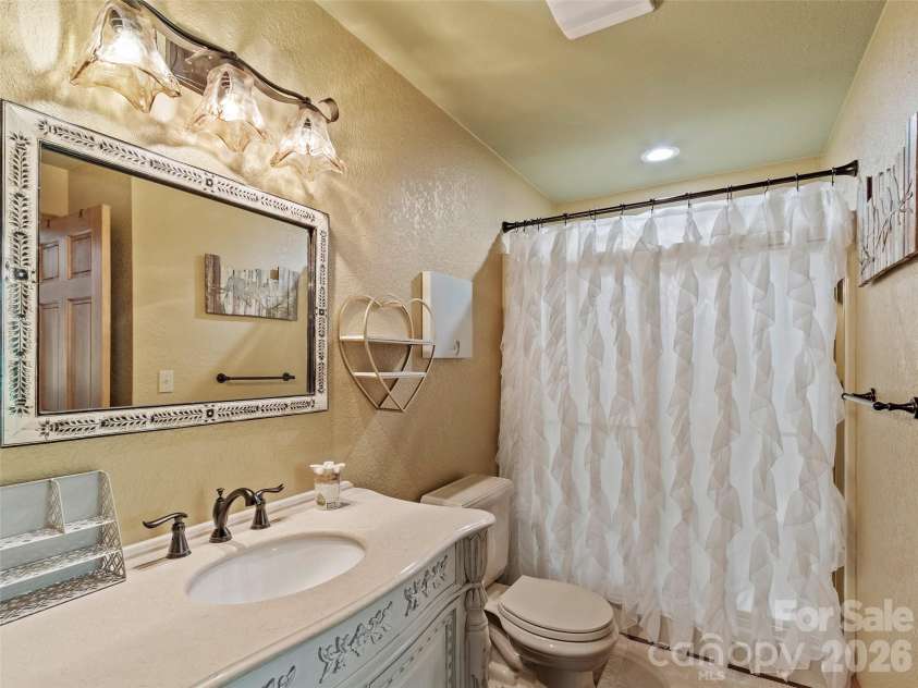 151 Austin Mountain Drive, Burnsville, NC 28714.  MLS# CAR4363639, YatesRealty ID 11563. Charming full bath with stylish custom vanity