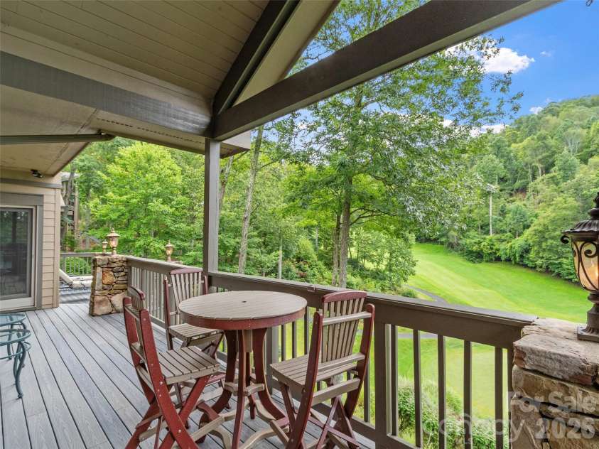 151 Austin Mountain Drive, Burnsville, NC 28714.  MLS# CAR4363639, YatesRealty ID 11563. Enjoy lunch on the deck while watching golfers on the fairway