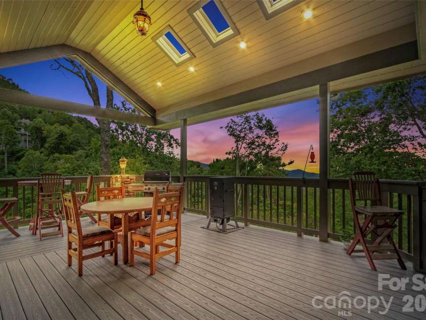 151 Austin Mountain Drive, Burnsville, NC 28714.  MLS# CAR4363639, YatesRealty ID 11563. Spacious covered outdoor dining area with stunning sunset views