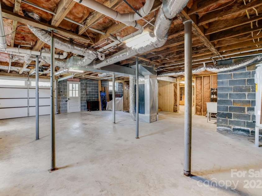 95 Hunters Ridge Road, Mills River, NC 28759.  MLS# CAR4244333, YatesRealty ID 11576. Basement garage/workshop area