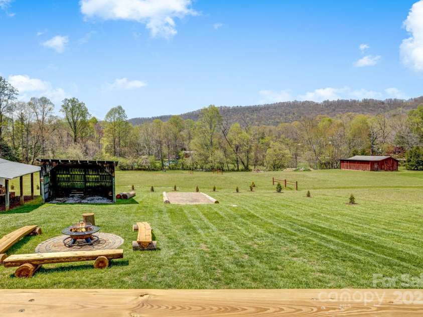 95 Hunters Ridge Road, Mills River, NC 28759.  MLS# CAR4244333, YatesRealty ID 11576. Fire pit and garden with views of the mountains