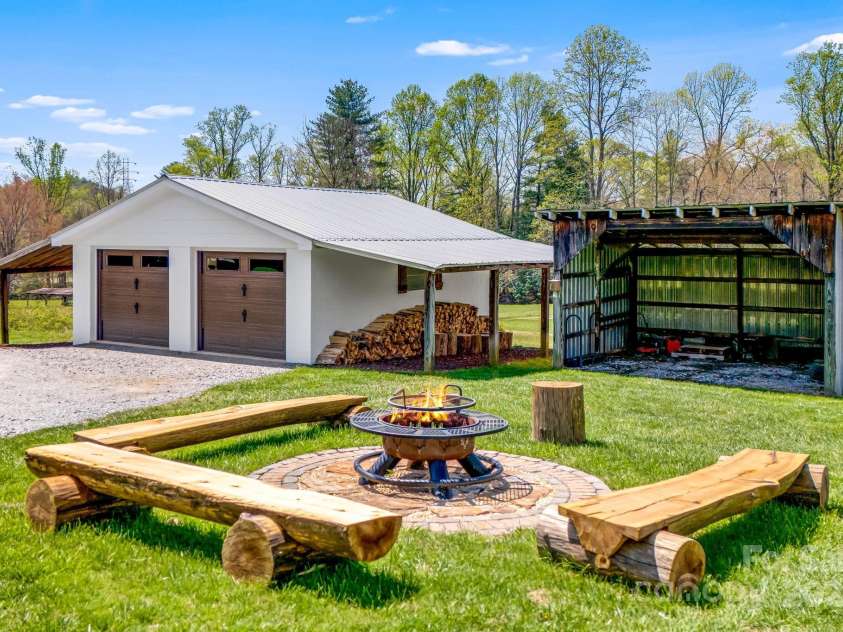 95 Hunters Ridge Road, Mills River, NC 28759.  MLS# CAR4244333, YatesRealty ID 11576. Fire pit with log benches