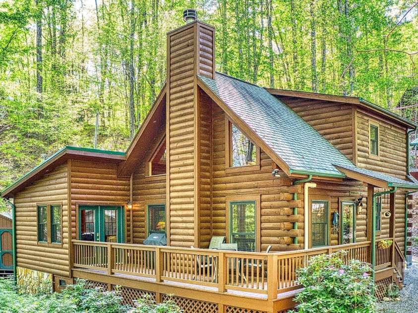 71 Honeymoon Lane, Maggie Valley, NC 28751.  MLS# CAR4240026, YatesRealty ID 11581. Cabin in Maggie Valley set amidst lush greenery and sunlight