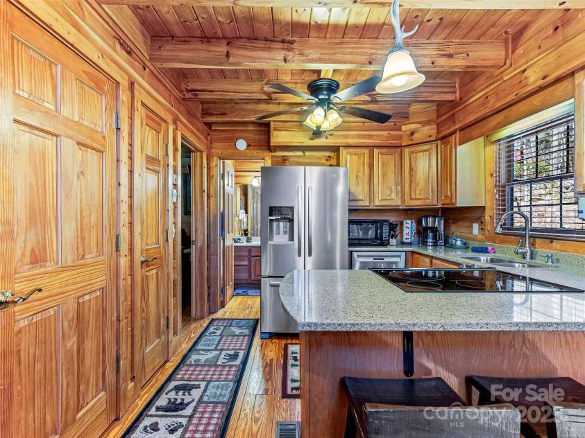 71 Honeymoon Lane, Maggie Valley, NC 28751.  MLS# CAR4240026, YatesRealty ID 11581. Looking in to kitchen with full bathroom in the distance.