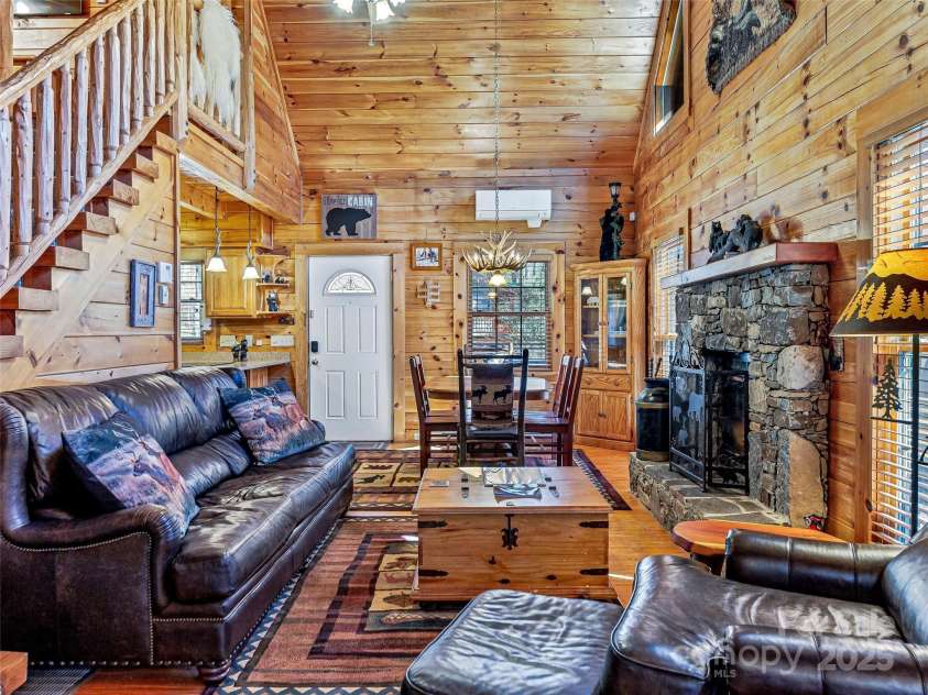 71 Honeymoon Lane, Maggie Valley, NC 28751.  MLS# CAR4240026, YatesRealty ID 11581. Looking in to the living room and dining area from the den.  Cozy, rustic charm!