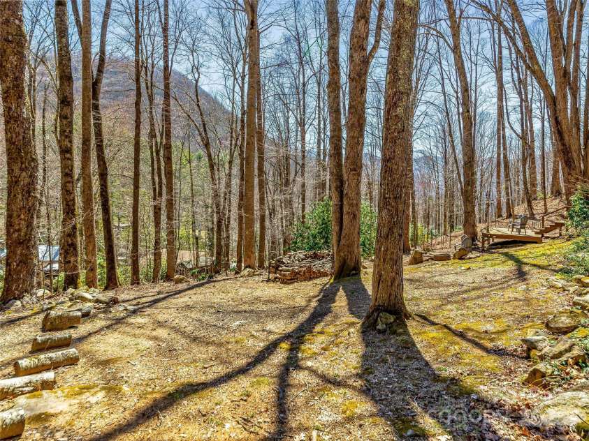 71 Honeymoon Lane, Maggie Valley, NC 28751.  MLS# CAR4240026, YatesRealty ID 11581. Viewing the property from driveway side of home.  Firepit and extra decking to the right