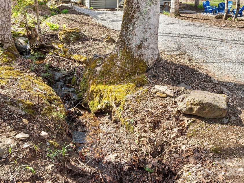 21 Susan Drive, Maggie Valley, NC 28751.  MLS# CAR4241989, YatesRealty ID 11582. Calming Creek that runs along the side of the property