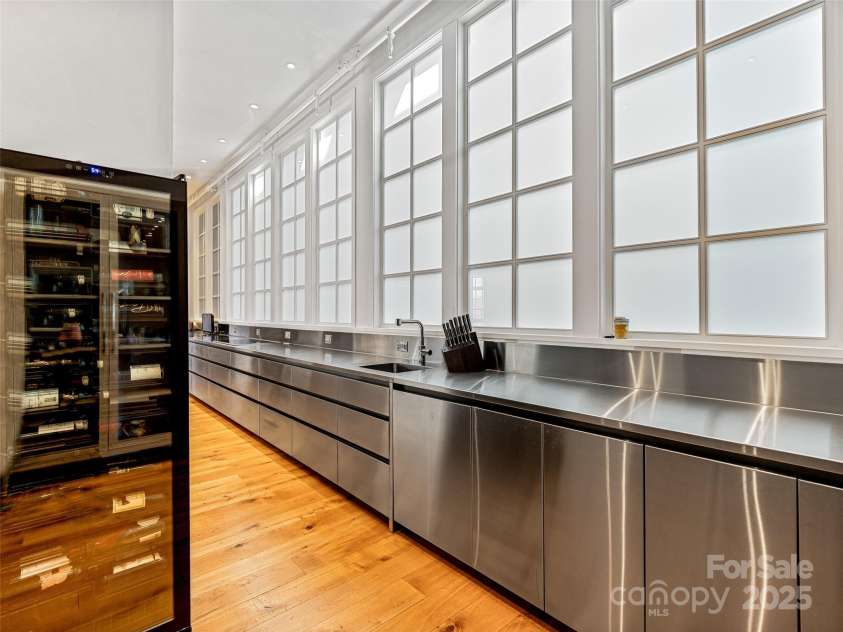 75 Broadway Street, Asheville, NC 28801.  MLS# CAR4219180, YatesRealty ID 11589. Butlers pantry and amazing light from the light well windows spanning the kitchen