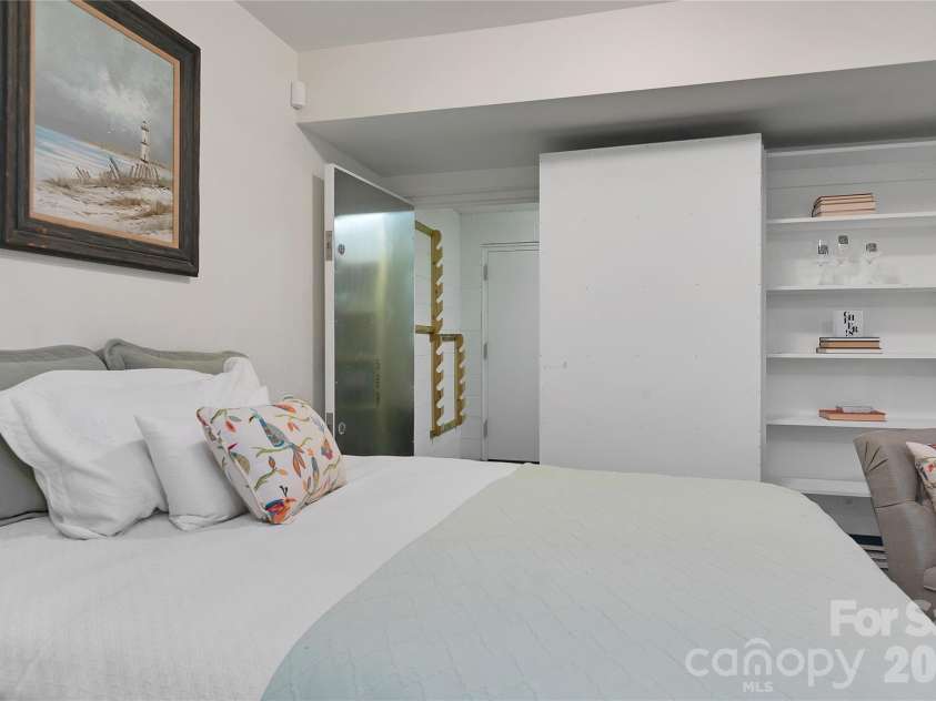 231 Cedar Lane, Brevard, NC 28712.  MLS# CAR4358033, YatesRealty ID 11596. Secret bookcase