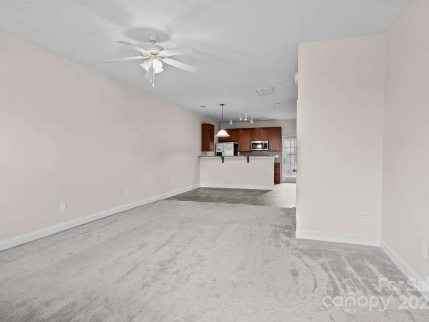 12550 McGrath Drive, Charlotte, NC 28269.  MLS# CAR4242569, YatesRealty ID 11597. Designed with entertaining in mind, the open-concept living and dining areas create a welcoming, connected atmosphere.
