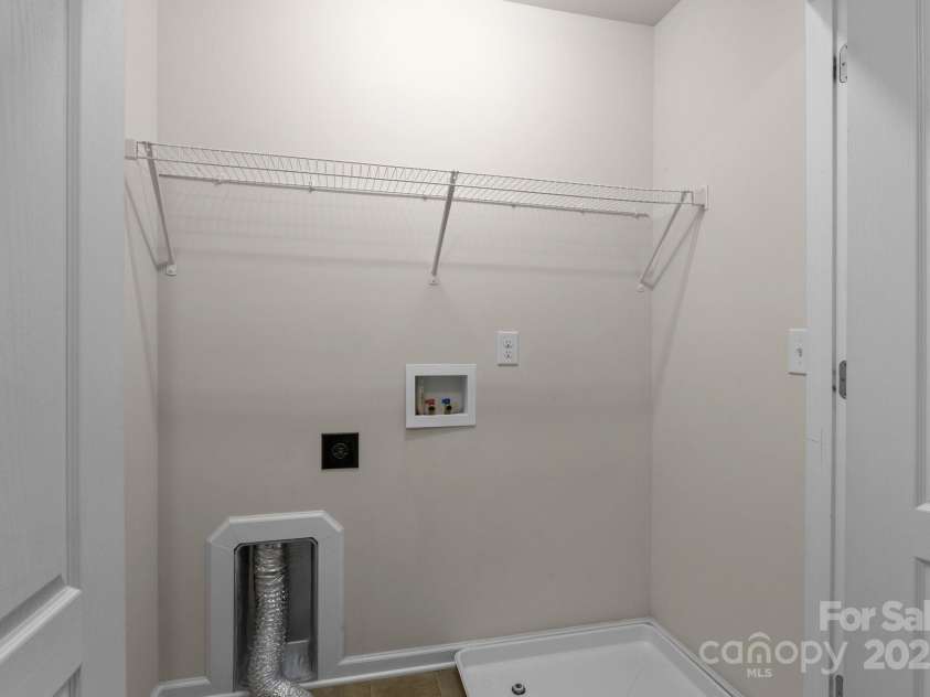 12550 McGrath Drive, Charlotte, NC 28269.  MLS# CAR4242569, YatesRealty ID 11597. Doing laundry's a breeze in this space located just off of the primary and secondary bedrooms.