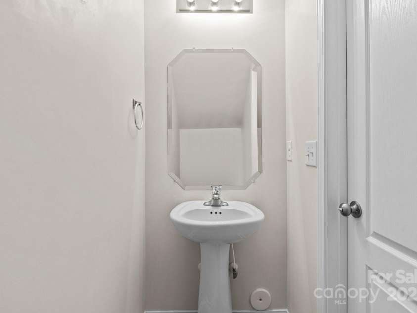 12550 McGrath Drive, Charlotte, NC 28269.  MLS# CAR4242569, YatesRealty ID 11597. Guests will appreciate this half bath located conveniently off of the living room!