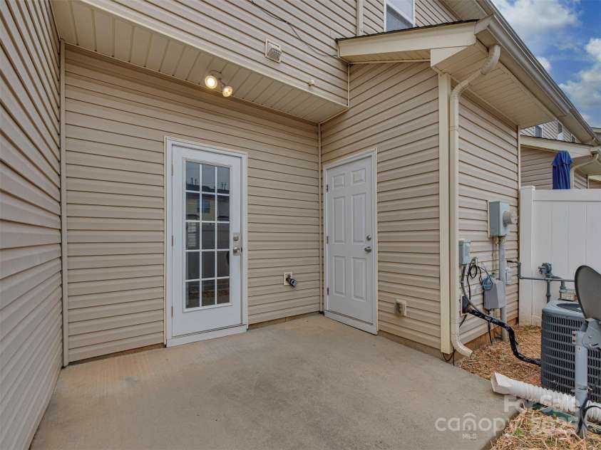 12550 McGrath Drive, Charlotte, NC 28269.  MLS# CAR4242569, YatesRealty ID 11597. Just off the kitchen, this fenced-in patio offers the perfect space for entertaining—or simply unwinding at the end of the day.