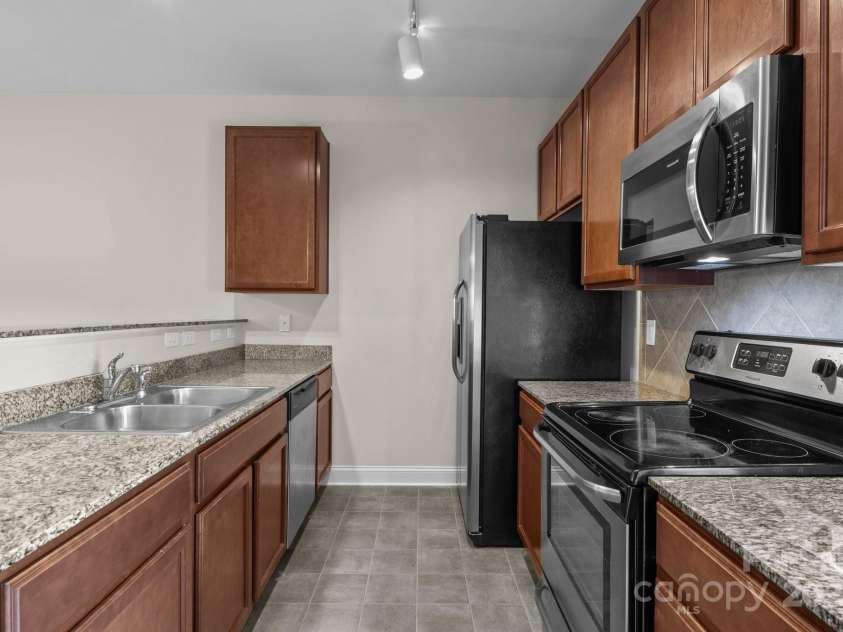 12550 McGrath Drive, Charlotte, NC 28269.  MLS# CAR4242569, YatesRealty ID 11597. Let your inner chef come out to play in this beautiful kitchen, equipped with granite countertops, shaker cabinets, and stainless steel appliances!