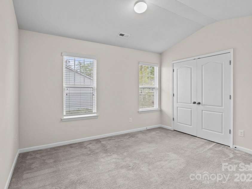 12550 McGrath Drive, Charlotte, NC 28269.  MLS# CAR4242569, YatesRealty ID 11597. Step into the serene primary bedroom, where natural light pours in and comfort continues with an en suite bath and spacious closets.