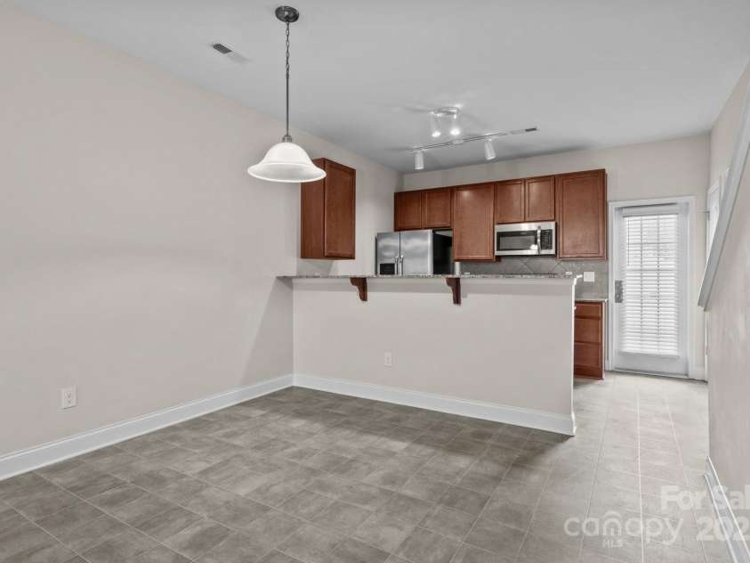 12550 McGrath Drive, Charlotte, NC 28269.  MLS# CAR4242569, YatesRealty ID 11597. Take a seat at the dining table or cozy up at the breakfast bar—there’s always a perfect spot to enjoy a delicious meal.