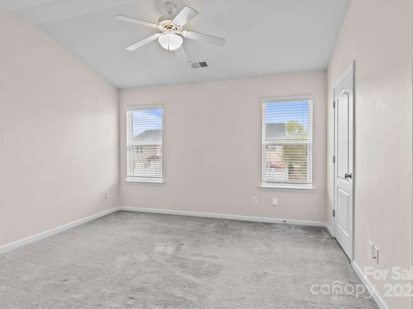 12550 McGrath Drive, Charlotte, NC 28269.  MLS# CAR4242569, YatesRealty ID 11597. This secondary bedroom  is bright, versatile, and features its own personal en suite bath.