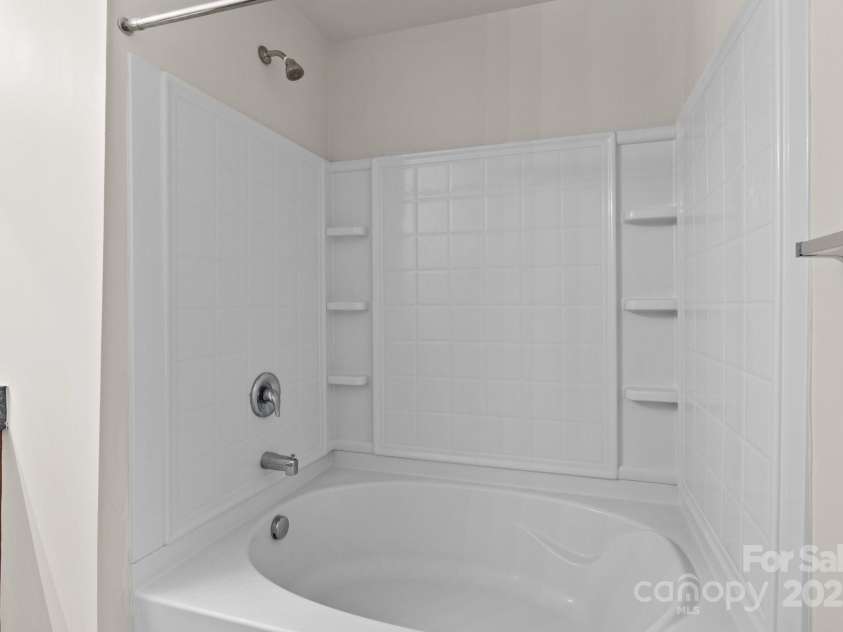 12550 McGrath Drive, Charlotte, NC 28269.  MLS# CAR4242569, YatesRealty ID 11597. Unwind in the spacious garden tub, tucked inside the tranquil en suite of your primary retreat.