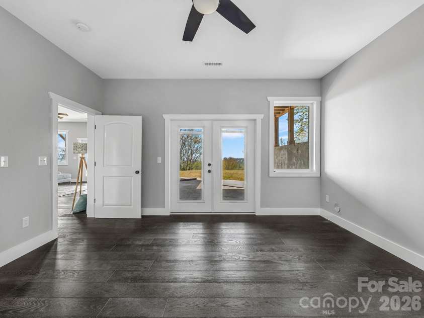 345 Preservation Trail, Columbus, NC 28722.  MLS# CAR4357487, YatesRealty ID 11600. Lower level bedroom ensuite #1 with bath and outside exit to patio.