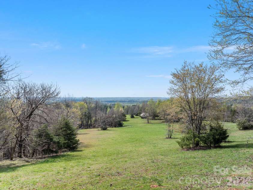 345 Preservation Trail, Columbus, NC 28722.  MLS# CAR4357487, YatesRealty ID 11600. Pasture with shady trees.