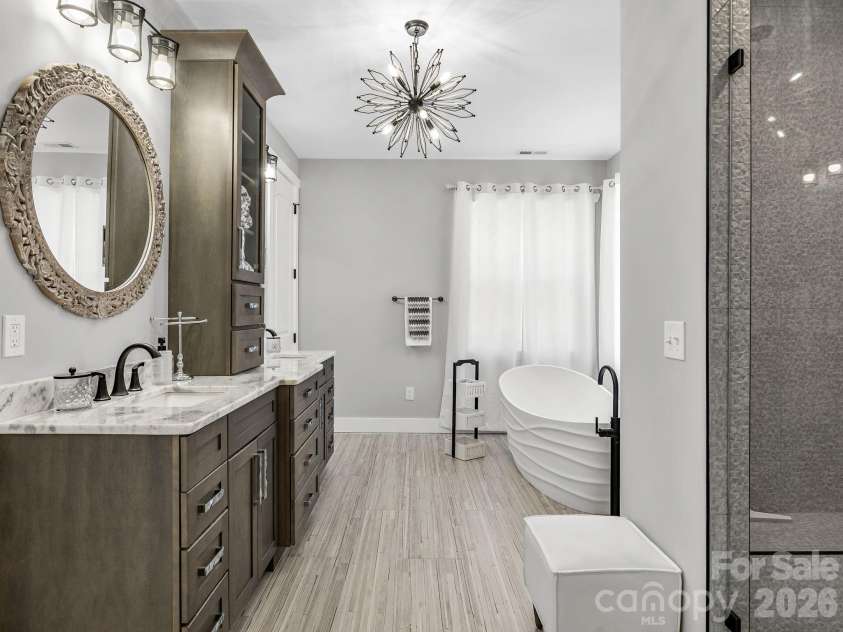 345 Preservation Trail, Columbus, NC 28722.  MLS# CAR4357487, YatesRealty ID 11600. Primary bath suite featuring double vanity, deep soaking tub and shower.