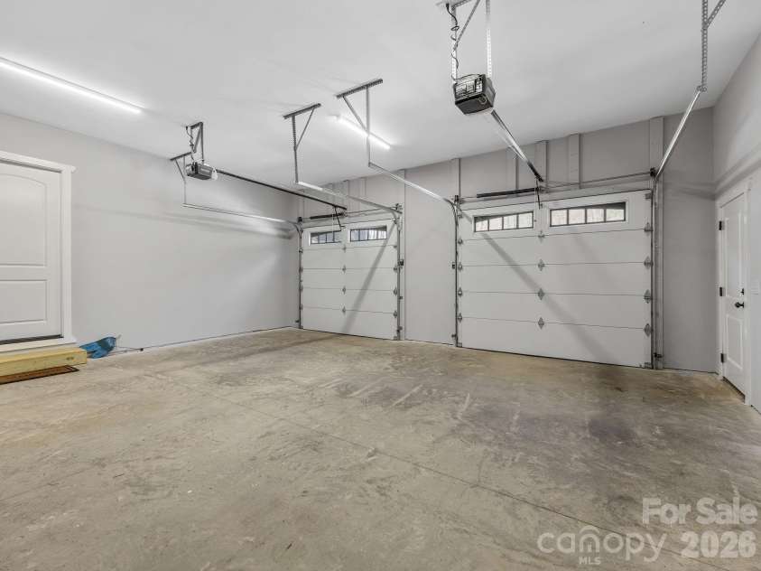 345 Preservation Trail, Columbus, NC 28722.  MLS# CAR4357487, YatesRealty ID 11600. Two car garage with exit door and entry door to main level.