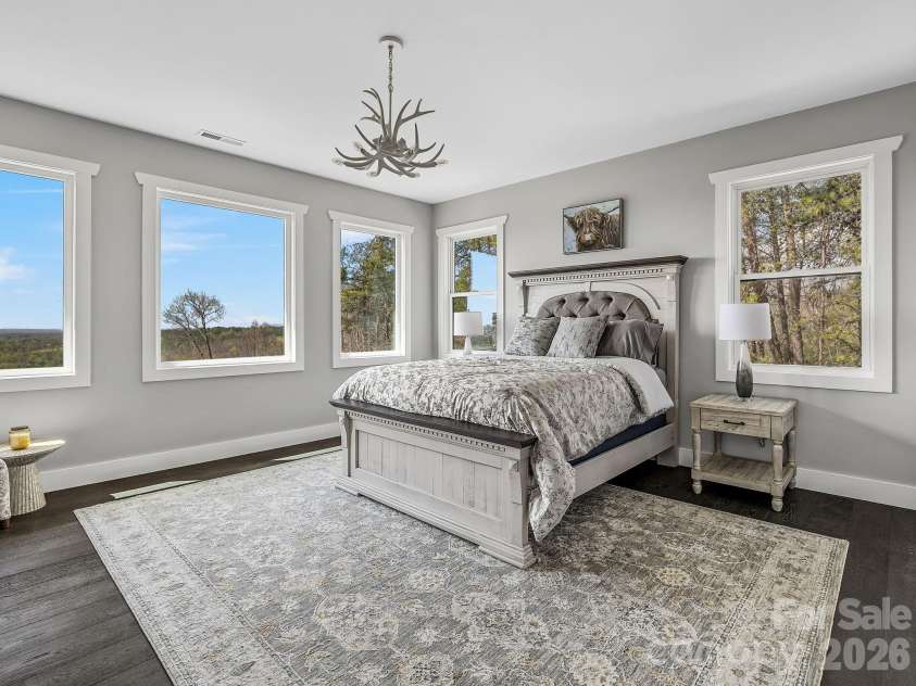 345 Preservation Trail, Columbus, NC 28722.  MLS# CAR4357487, YatesRealty ID 11600. Upper floor primary suite with large windows and long range views.