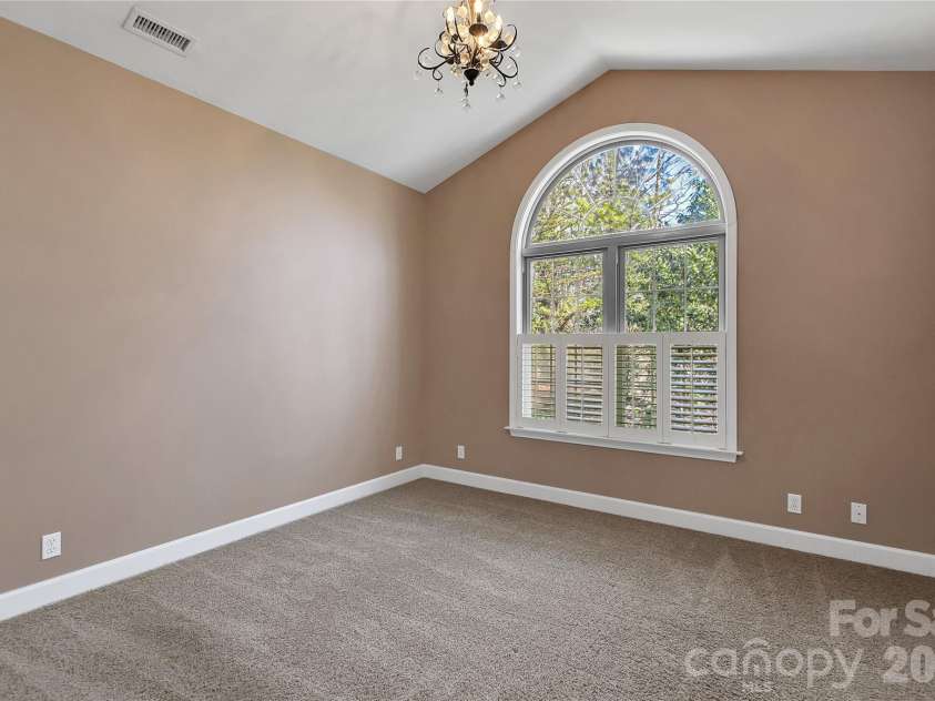 63 Wanei Court, Brevard, NC 28712.  MLS# CAR4359510, YatesRealty ID 11607. 1st guest bedroom with arched window
