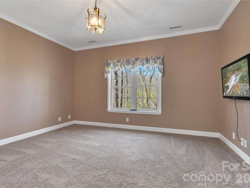 63 Wanei Court, Brevard, NC 28712.  MLS# CAR4359510, YatesRealty ID 11607. Primary Bedroom with views out the window