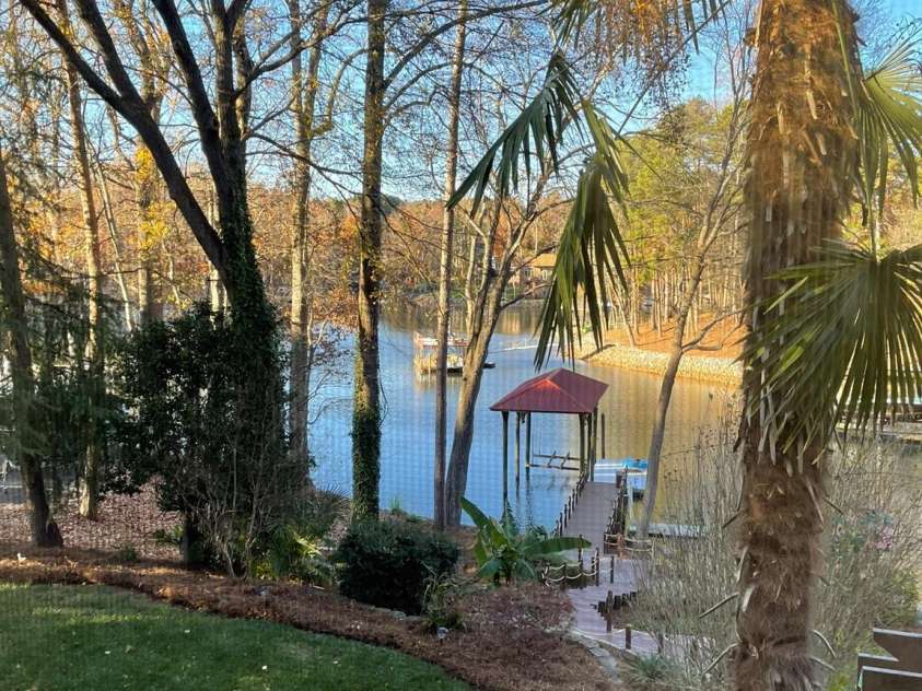 377 Riverwood Road, Mooresville, NC 28117.  MLS# CAR4192992, YatesRealty ID 11616. Beautiful landscaping includes palm trees and well-established plants, trees, and yard! Stone pavers with plants in terraced yard.