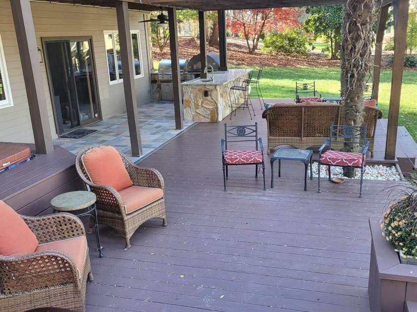 377 Riverwood Road, Mooresville, NC 28117.  MLS# CAR4192992, YatesRealty ID 11616. Extensive decking provides tons of different areas to entertain...patio, pergola, built-in seating & planters, and upper deck leading into screened-in-porch.