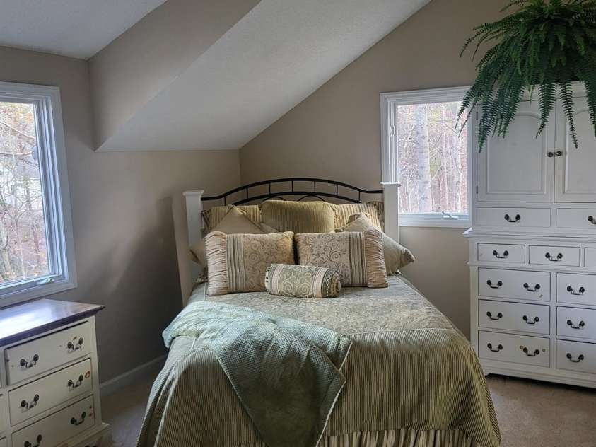 377 Riverwood Road, Mooresville, NC 28117.  MLS# CAR4192992, YatesRealty ID 11616. Lakeside upstairs bedroom with new ceiling fan and walk-in closet. Brand new carpet!