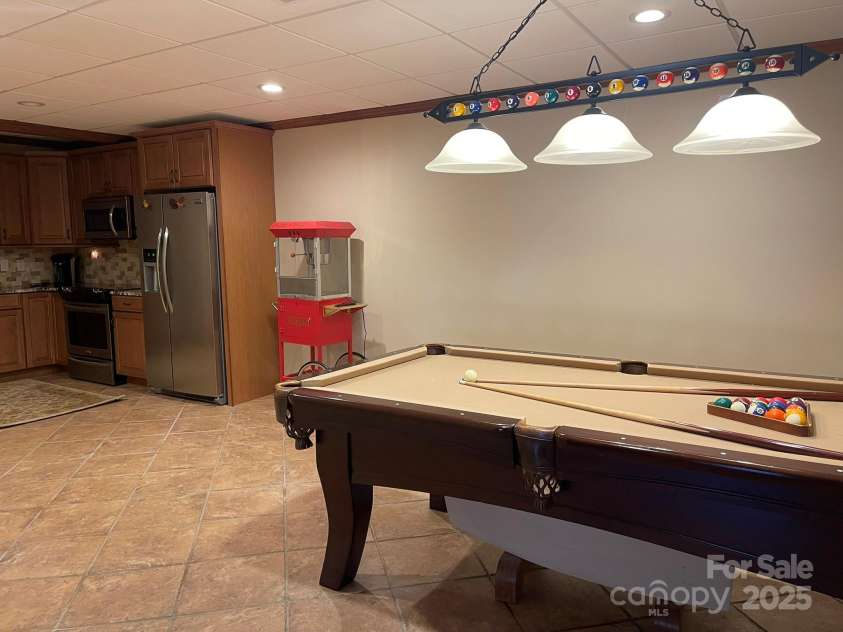 377 Riverwood Road, Mooresville, NC 28117.  MLS# CAR4192992, YatesRealty ID 11616. View into rec room/ kitchen area. Pool table and billiard light included!