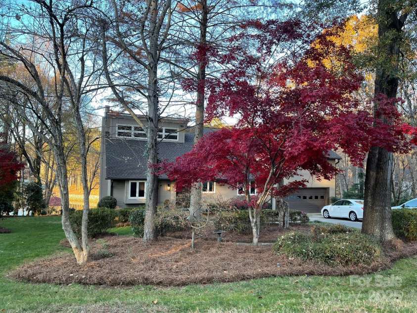 377 Riverwood Road, Mooresville, NC 28117.  MLS# CAR4192992, YatesRealty ID 11616. Yard features mature plants and trees that offer color and beauty year-round.  Driveway features plenty of parking and side pad.