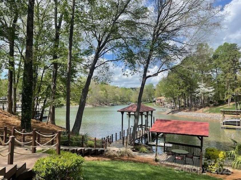 377 Riverwood Road, Mooresville, NC 28117.  MLS# CAR4192992, YatesRealty ID 11616. Year-round water at the dock. Boat lift is a 7000 pound cable lift that can hold most big boats on this lake.
