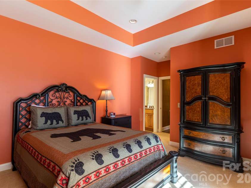 446 Windridge Drive, Sugar Grove, NC 28679.  MLS# CAR4360975, YatesRealty ID 11618. Affectionately called the bear room this large bedroom on lowr level has access to lower deck, big walk in closet and cheerful paint color.