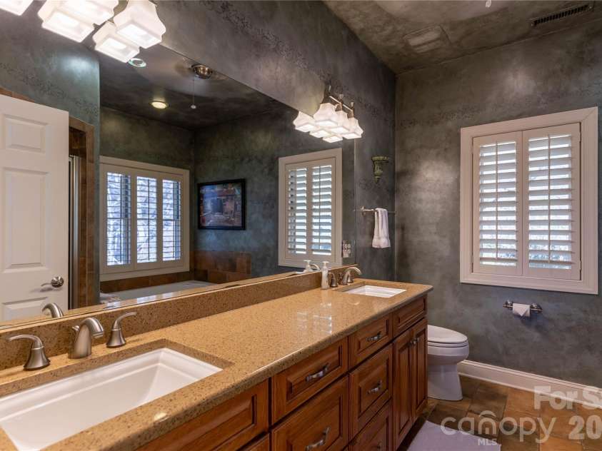 446 Windridge Drive, Sugar Grove, NC 28679.  MLS# CAR4360975, YatesRealty ID 11618. Master bath has dual granite counters with two under mount sinks, tile floors and separate jetted tub and shower.