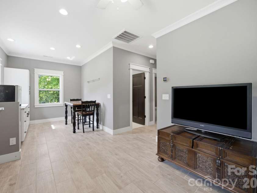 6207 Victory Pass Lane, Waxhaw, NC 28173.  MLS# CAR4398111, YatesRealty ID 11639. Living room & Kitchen. Guest house also features two bedrooms, laundry & bath with zero entry shower