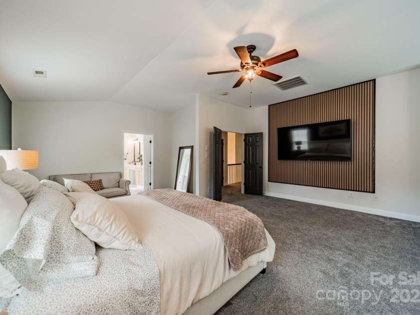 117 Middleton Place, Mooresville, NC 28117.  MLS# CAR4243590, YatesRealty ID 11681. TV Mount on Accent Wall in Primary Bedroom