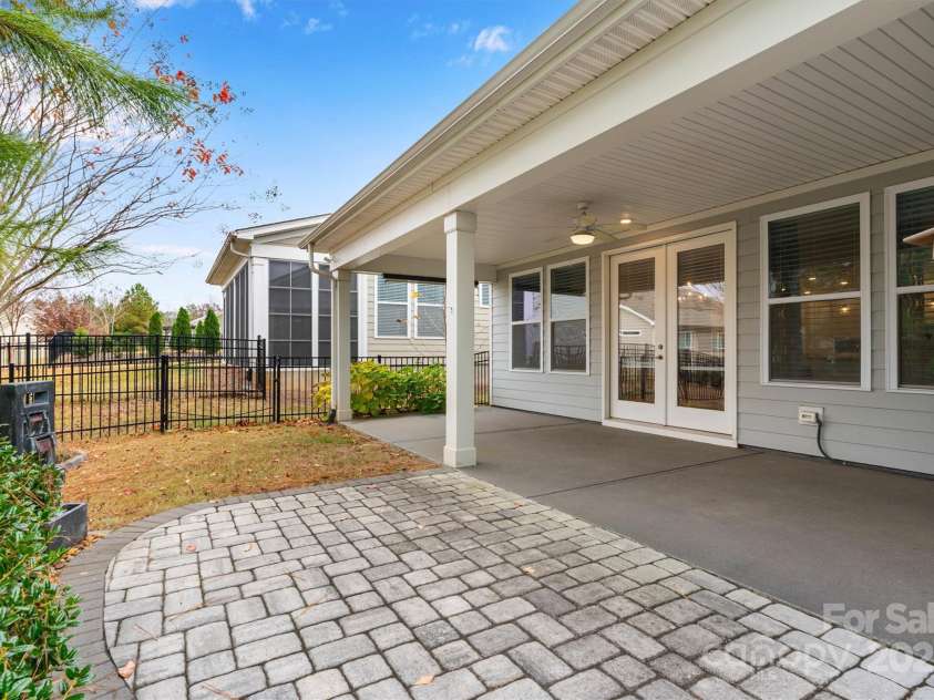 8210 Festival Way, Charlotte, NC 28215.  MLS# CAR4324351, YatesRealty ID 11707. Backyard bliss! Fenced with added landscaping for privacy, complete with a covered lanai, paver patio, and a  tranquil water feature.