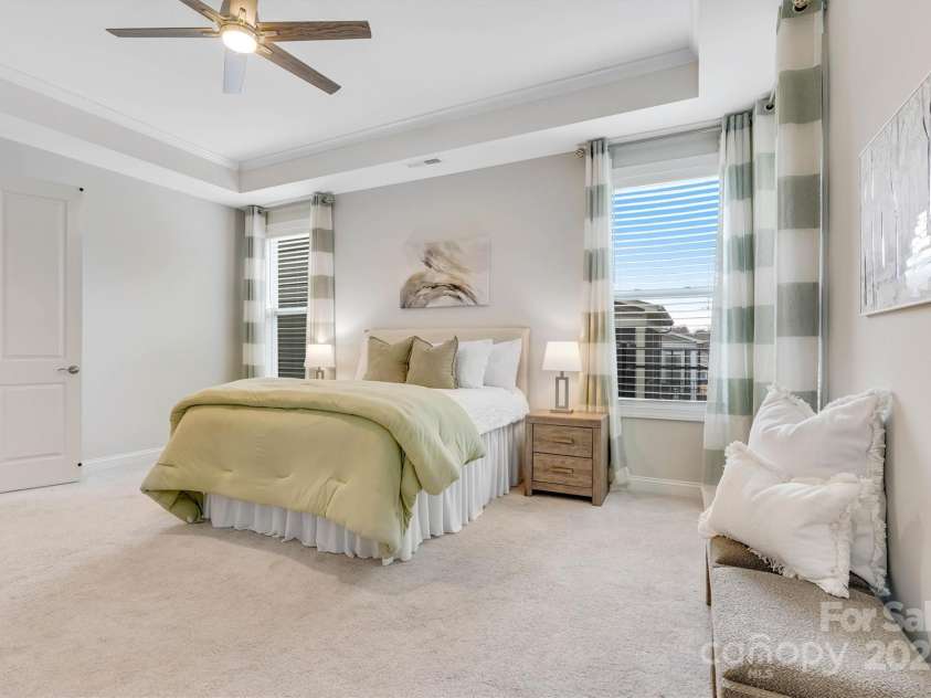 8210 Festival Way, Charlotte, NC 28215.  MLS# CAR4324351, YatesRealty ID 11707. French doors open to luxury—tile shower with bench, dual vanities, and a closet that’s pure perfection