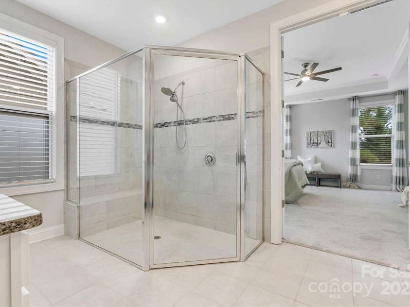 8210 Festival Way, Charlotte, NC 28215.  MLS# CAR4324351, YatesRealty ID 11707. From sunlit mornings to spa-like evenings, this ensuite has everything you need and more.