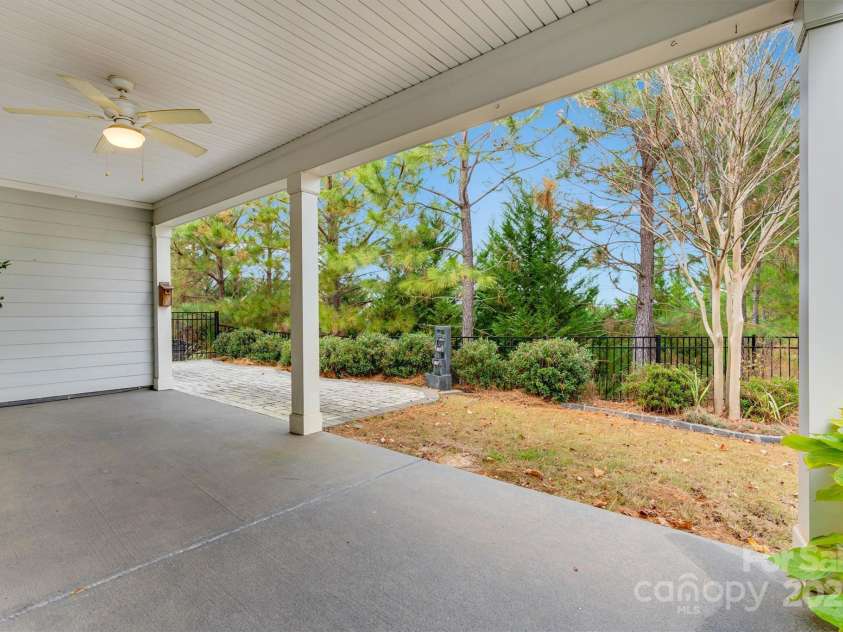 8210 Festival Way, Charlotte, NC 28215.  MLS# CAR4324351, YatesRealty ID 11707. Relax, entertain, repeat - fenced yard with a dreamy covered lanai and a soothing water feature.