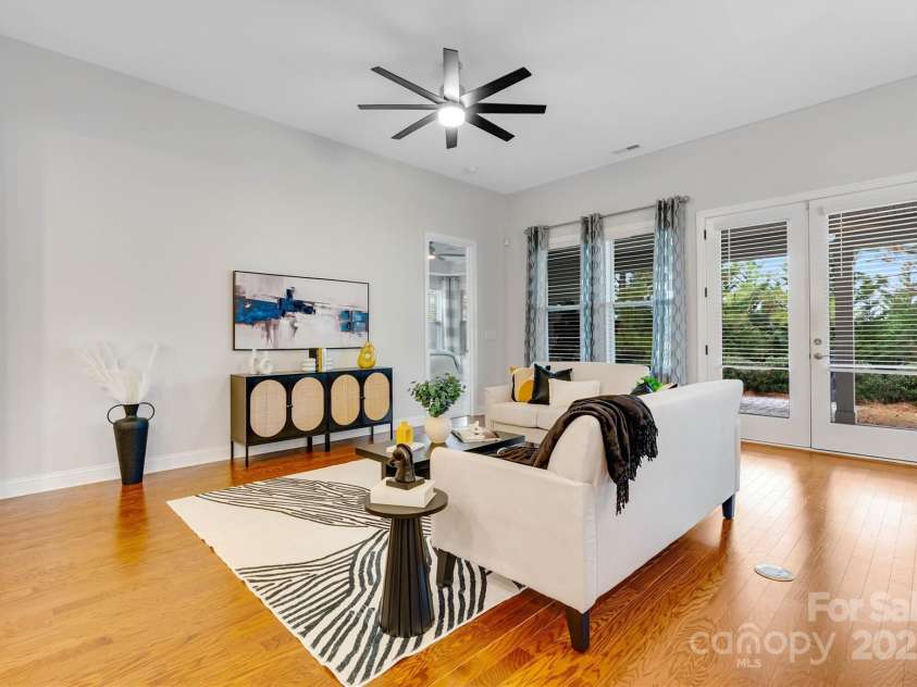 8210 Festival Way, Charlotte, NC 28215.  MLS# CAR4324351, YatesRealty ID 11707. Spacious living area opens to a covered lanai, filling the space with natural light and a touch of the outdoors.
