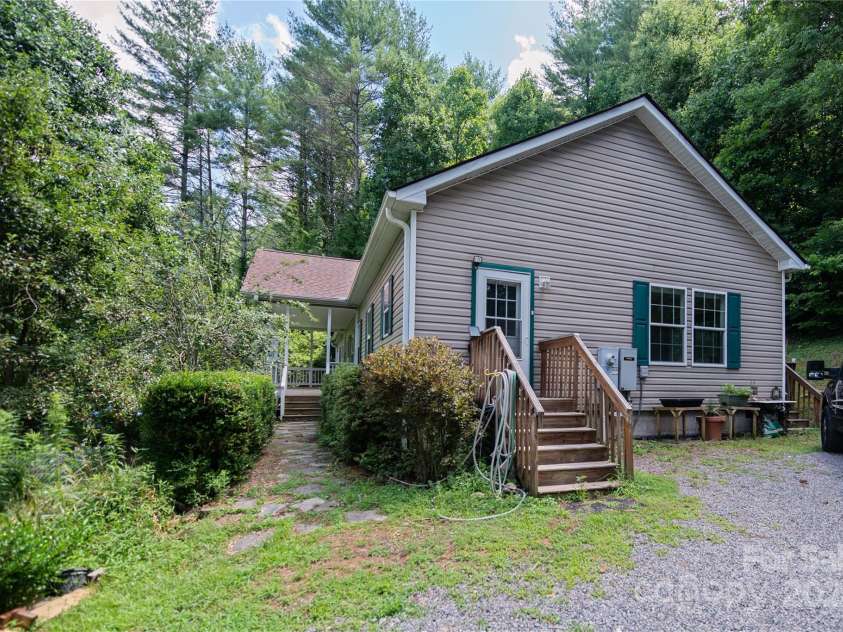 124 Wilds Branch Road, Marshall, NC 28753.  MLS# CAR4152556, YatesRealty ID 11710. Home is surrounded by mature fruit trees