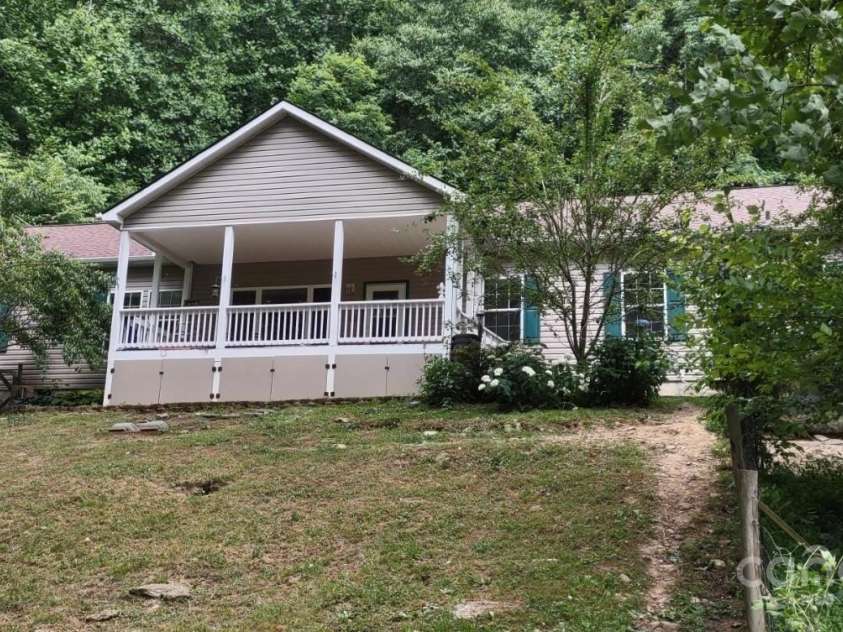 124 Wilds Branch Road, Marshall, NC 28753.  MLS# CAR4152556, YatesRealty ID 11710. Sweet front porch has fully fenced dog yard